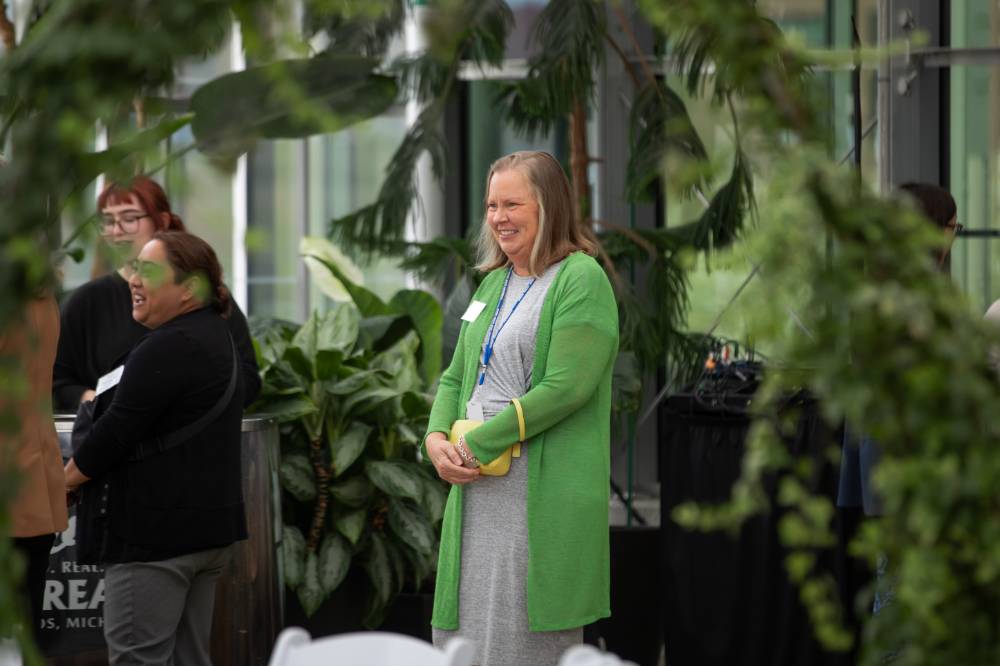 Annie Valkema standing, smiling at something off camera